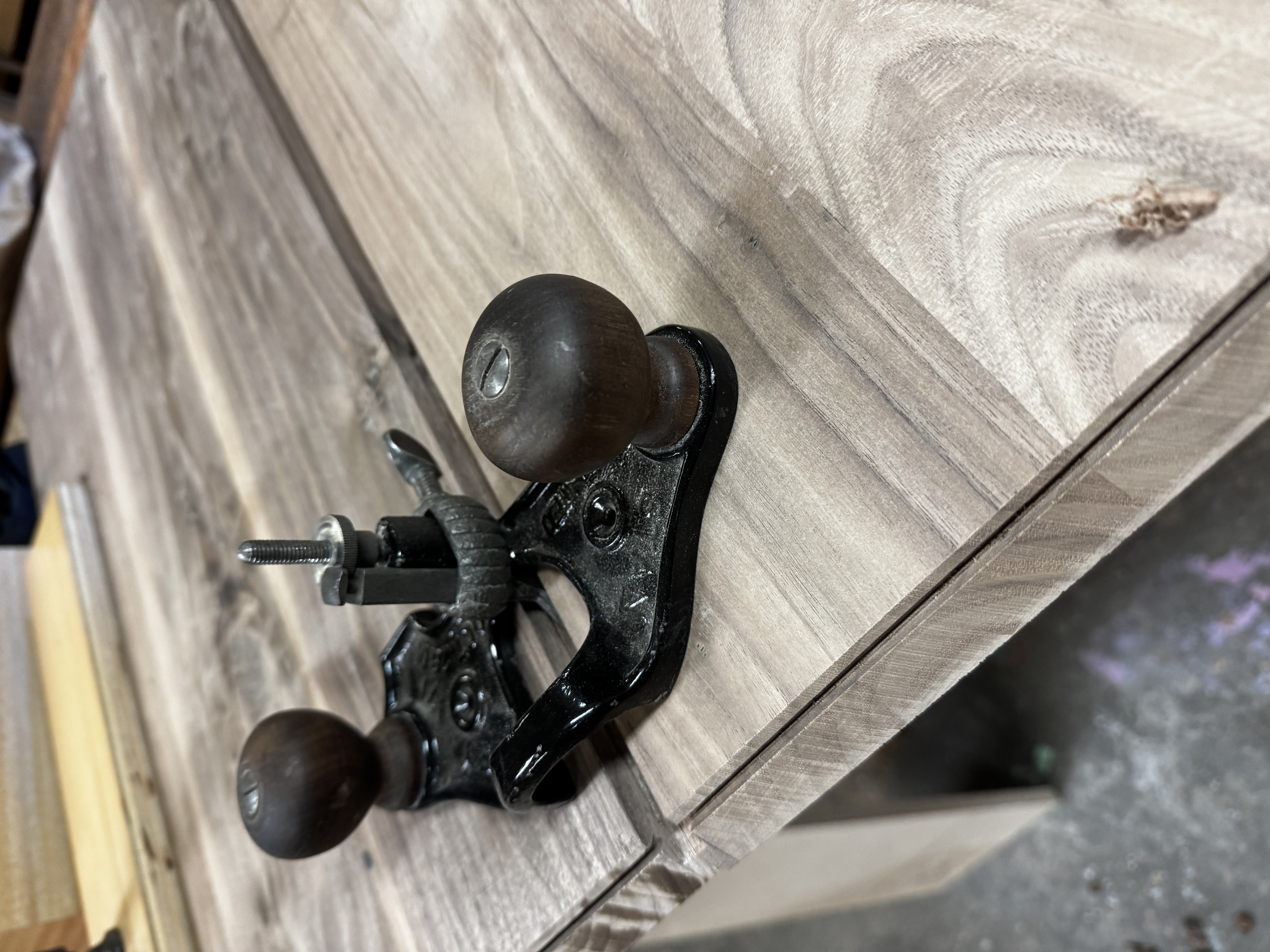 Using a hand router to create joining edges for the cabinet panels.